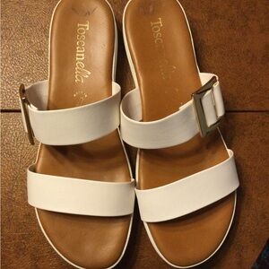 Toscanella super cute white buckle slip on wedge sandals.